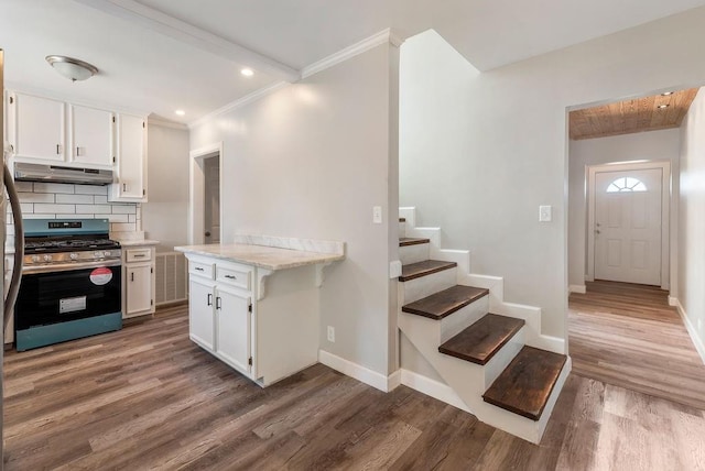 kitchen featuring backsplash, stainless steel range, white cabinets, and wood-type flooring