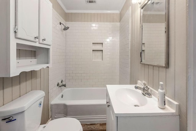 full bathroom featuring tiled shower / bath, crown molding, vanity, and toilet