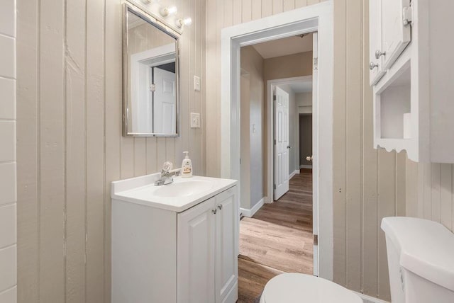 bathroom featuring hardwood / wood-style floors, vanity, and toilet