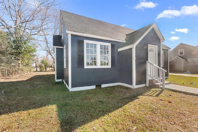 view of home's exterior with a lawn