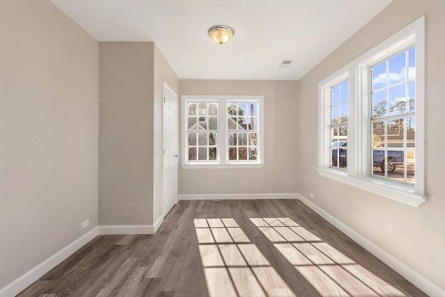 spare room with dark hardwood / wood-style flooring