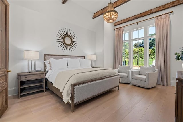 bedroom featuring a notable chandelier, beam ceiling, and light hardwood / wood-style flooring