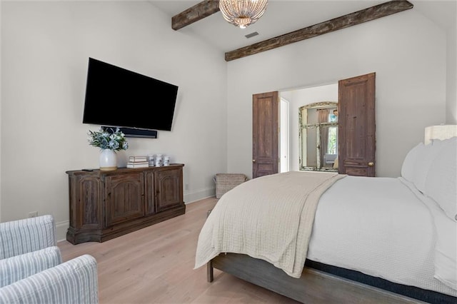 bedroom featuring beam ceiling and light wood-type flooring