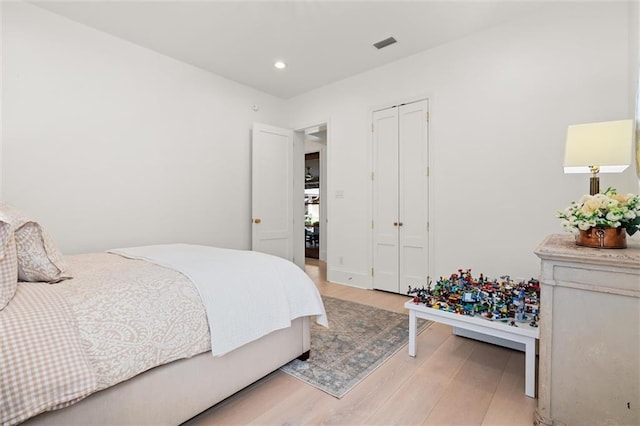 bedroom featuring light wood-type flooring and a closet