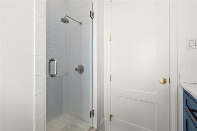 bathroom featuring vanity and a shower with shower door