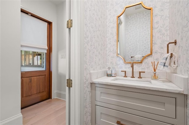 bathroom with hardwood / wood-style flooring and vanity