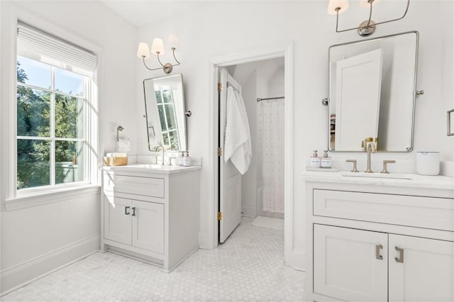 bathroom featuring walk in shower, vanity, and tile patterned flooring