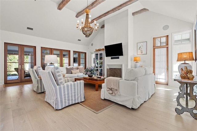 living room featuring beamed ceiling, high vaulted ceiling, light hardwood / wood-style floors, and french doors