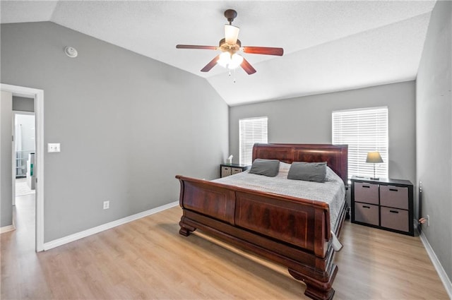 bedroom with lofted ceiling, light hardwood / wood-style floors, and ceiling fan