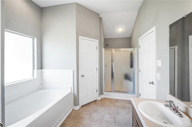 bathroom featuring lofted ceiling, vanity, plus walk in shower, and tile patterned floors