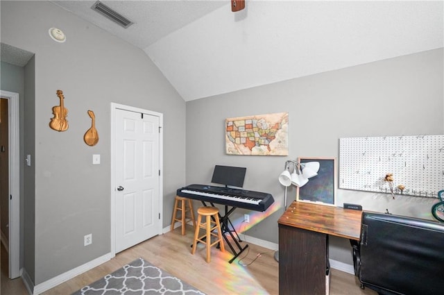 office featuring light wood-type flooring and lofted ceiling