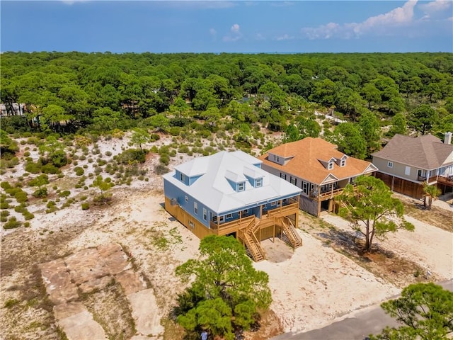 drone / aerial view featuring a wooded view