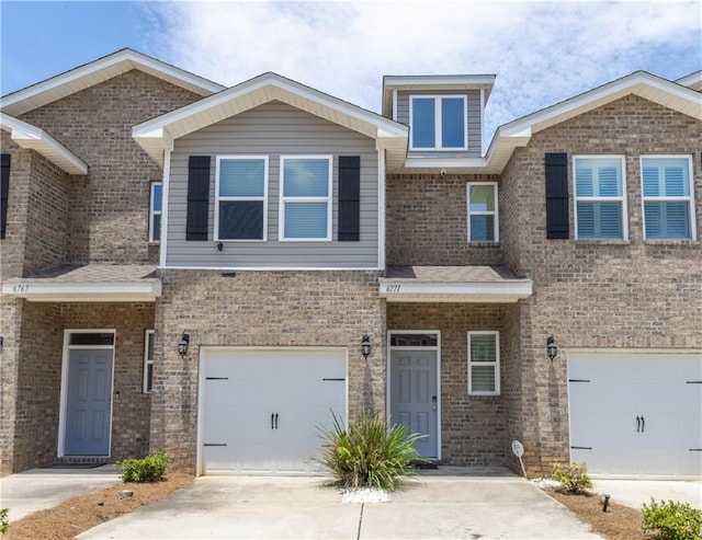 6771 Spaniel Dr Unit 3A, Spanish Fort, AL 36527 - view of front of home featuring an attached garage, concrete driveway, and brick siding