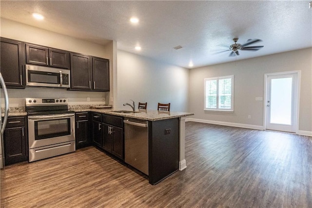6771 Spaniel Dr Unit 3A, Spanish Fort, AL 36527 - kitchen with stainless steel appliances, a ceiling fan, dark wood-type flooring, a peninsula, and recessed lighting
