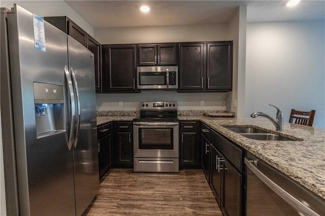 6771 Spaniel Dr Unit 3A, Spanish Fort, AL 36527 - kitchen with stainless steel appliances, light stone countertops, dark wood-style flooring, and recessed lighting