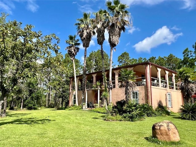 rear view of house featuring a yard