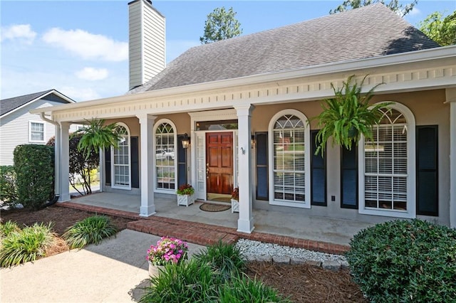 6417 Magnolia Place Ct S, Mobile, AL 36695 - property entrance featuring a shingled roof, covered porch, and a chimney