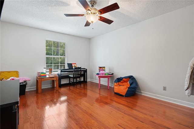 6417 Magnolia Place Ct S, Mobile, AL 36695 - recreation room with baseboards, a textured ceiling, ceiling fan, and wood finished floors