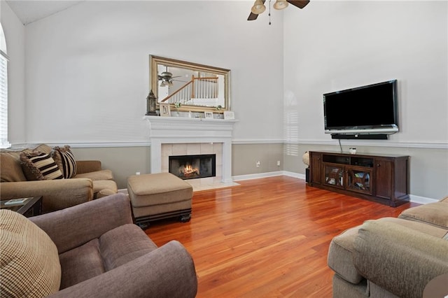 6417 Magnolia Place Ct S, Mobile, AL 36695 - living area featuring a tiled fireplace, high vaulted ceiling, ceiling fan, and wood finished floors