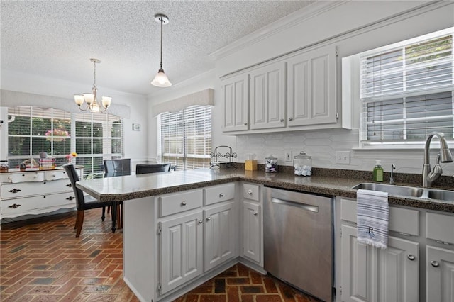 6417 Magnolia Place Ct S, Mobile, AL 36695 - kitchen with a notable chandelier, a sink, brick floor, dishwasher, and a peninsula
