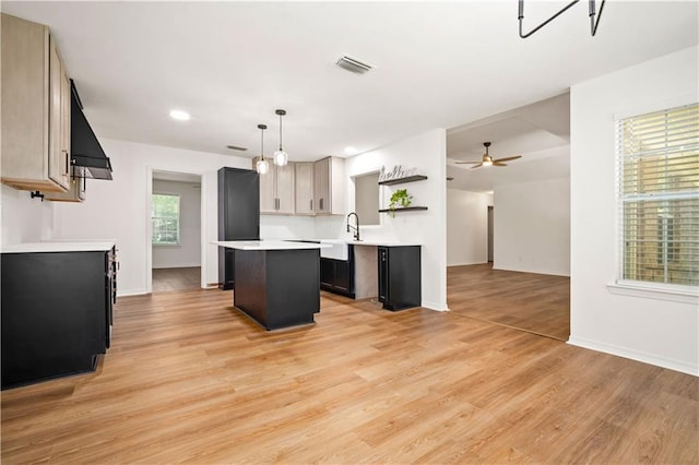 5108 Highcrest Dr, Mobile, AL 36693 - kitchen with custom exhaust hood, a kitchen island, light countertops, light wood finished floors, and open shelves