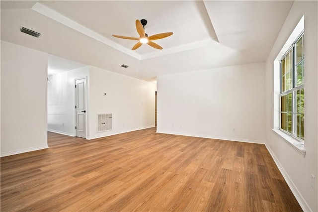 5108 Highcrest Dr, Mobile, AL 36693 - empty room featuring a raised ceiling, a ceiling fan, and light wood-type flooring