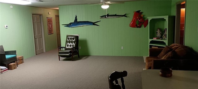 sitting room with carpet floors and ceiling fan