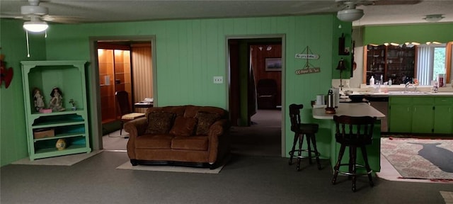 living room with ceiling fan and sink