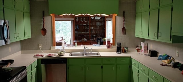 kitchen featuring appliances with stainless steel finishes, green cabinets, and sink