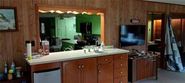 bathroom with wood walls, sink, and ceiling fan