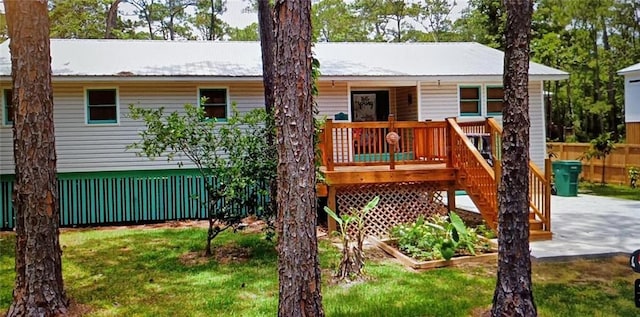 exterior space featuring a deck and a yard