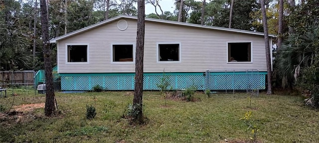 view of side of home with a lawn