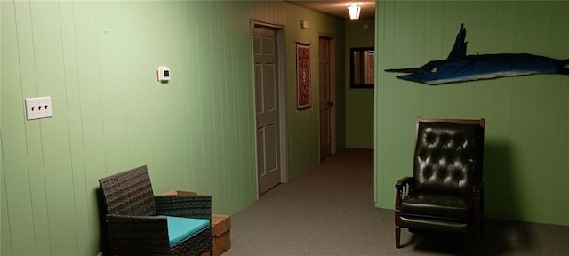 hallway with light carpet and wooden walls