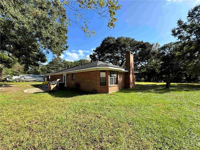 view of side of home featuring a yard