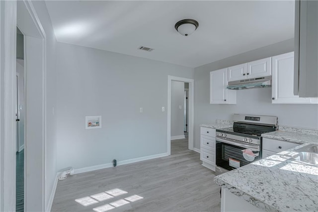 kitchen featuring light stone counters, stainless steel range, light wood-type flooring, and white cabinets