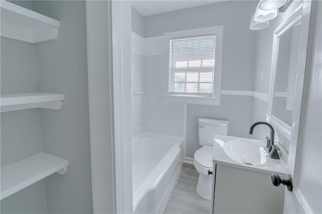 bathroom with vanity, hardwood / wood-style floors, and toilet