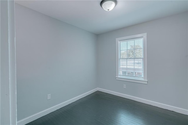 spare room with dark wood-type flooring