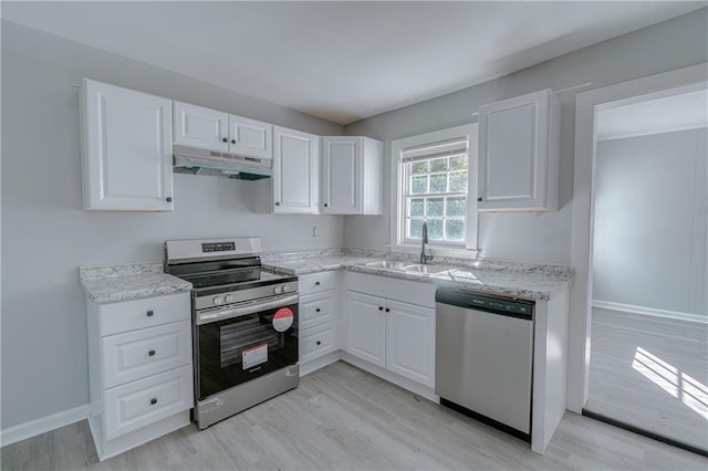 kitchen with sink, light hardwood / wood-style flooring, stainless steel appliances, light stone countertops, and white cabinets