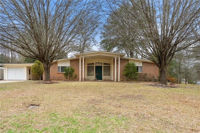 ranch-style home featuring a garage and a front lawn