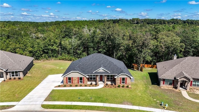 bird's eye view with a wooded view