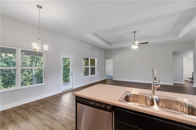 kitchen featuring sink, hanging light fixtures, dark hardwood / wood-style floors, dishwasher, and a raised ceiling