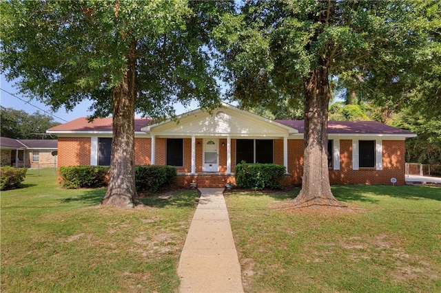 view of front of home with covered porch and a front yard