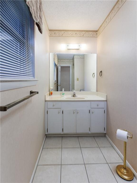 bathroom featuring tile patterned flooring, vanity, ornamental molding, and a textured ceiling