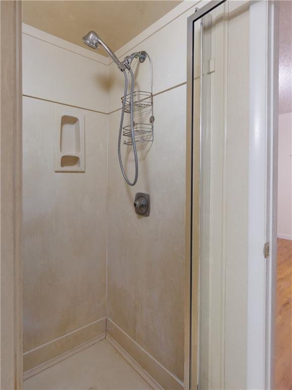 bathroom with a tile shower