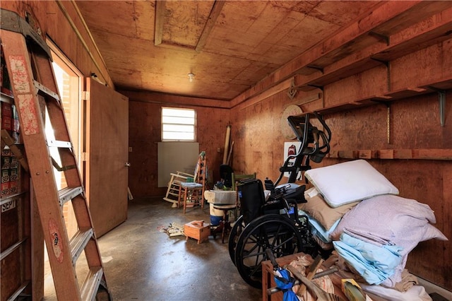 misc room with concrete floors and wooden walls