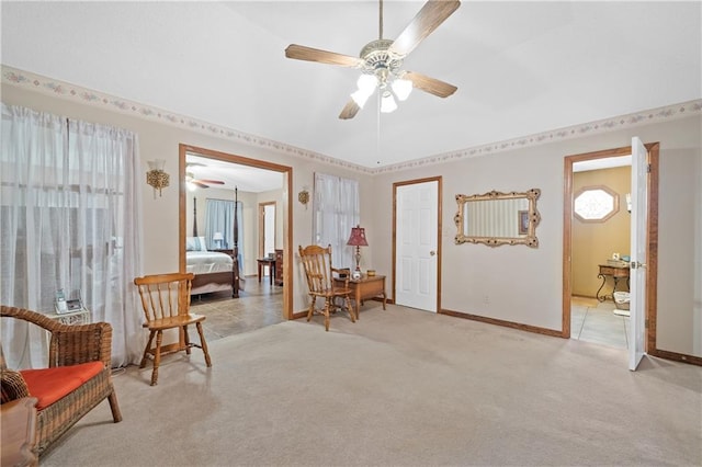 living area featuring ceiling fan and light colored carpet