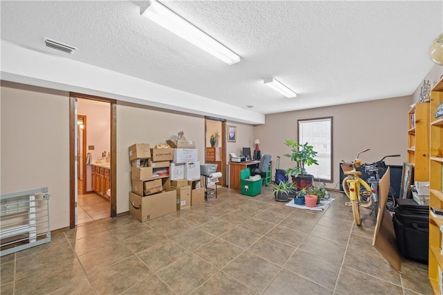 basement featuring a textured ceiling