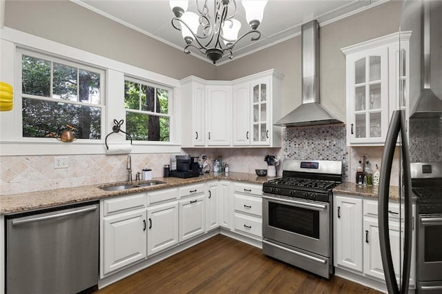 13 Demouy Ave, Mobile, AL 36606 - kitchen with appliances with stainless steel finishes, wall chimney exhaust hood, a sink, white cabinetry, and ornamental molding