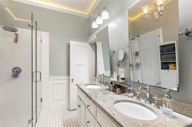 13 Demouy Ave, Mobile, AL 36606 - bathroom featuring a shower stall, crown molding, double vanity, and wainscoting