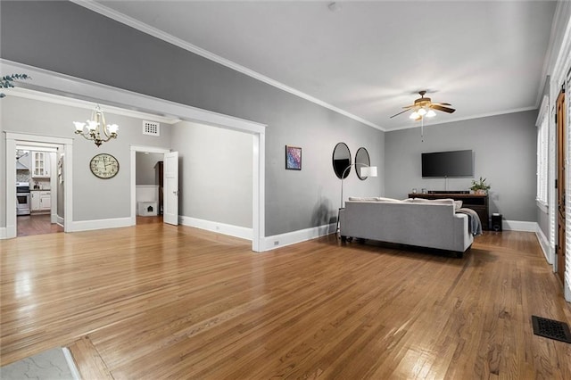 13 Demouy Ave, Mobile, AL 36606 - living area featuring light wood-style floors, ceiling fan, a chandelier, baseboards, and crown molding